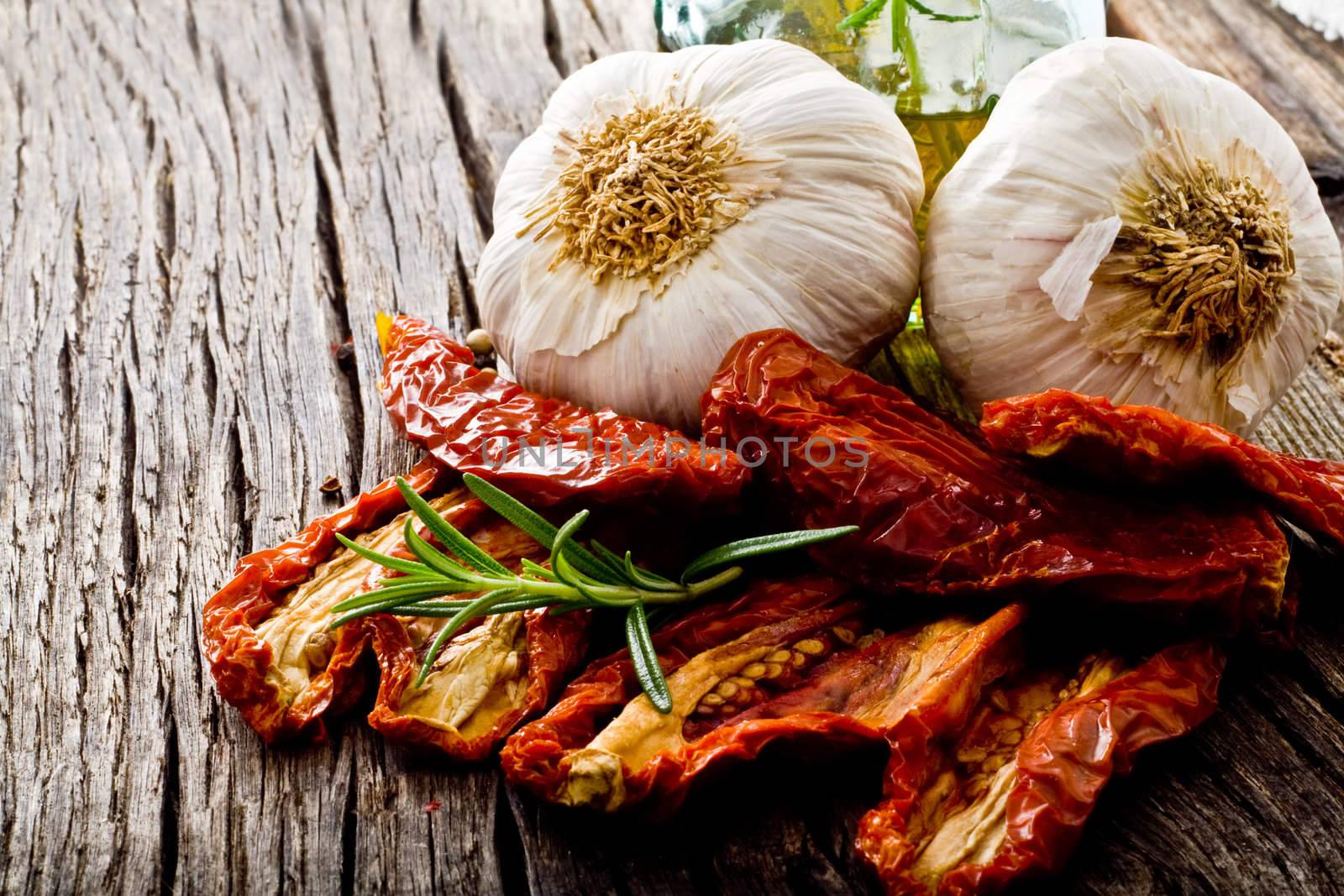 dried red tomato on wood with garlic