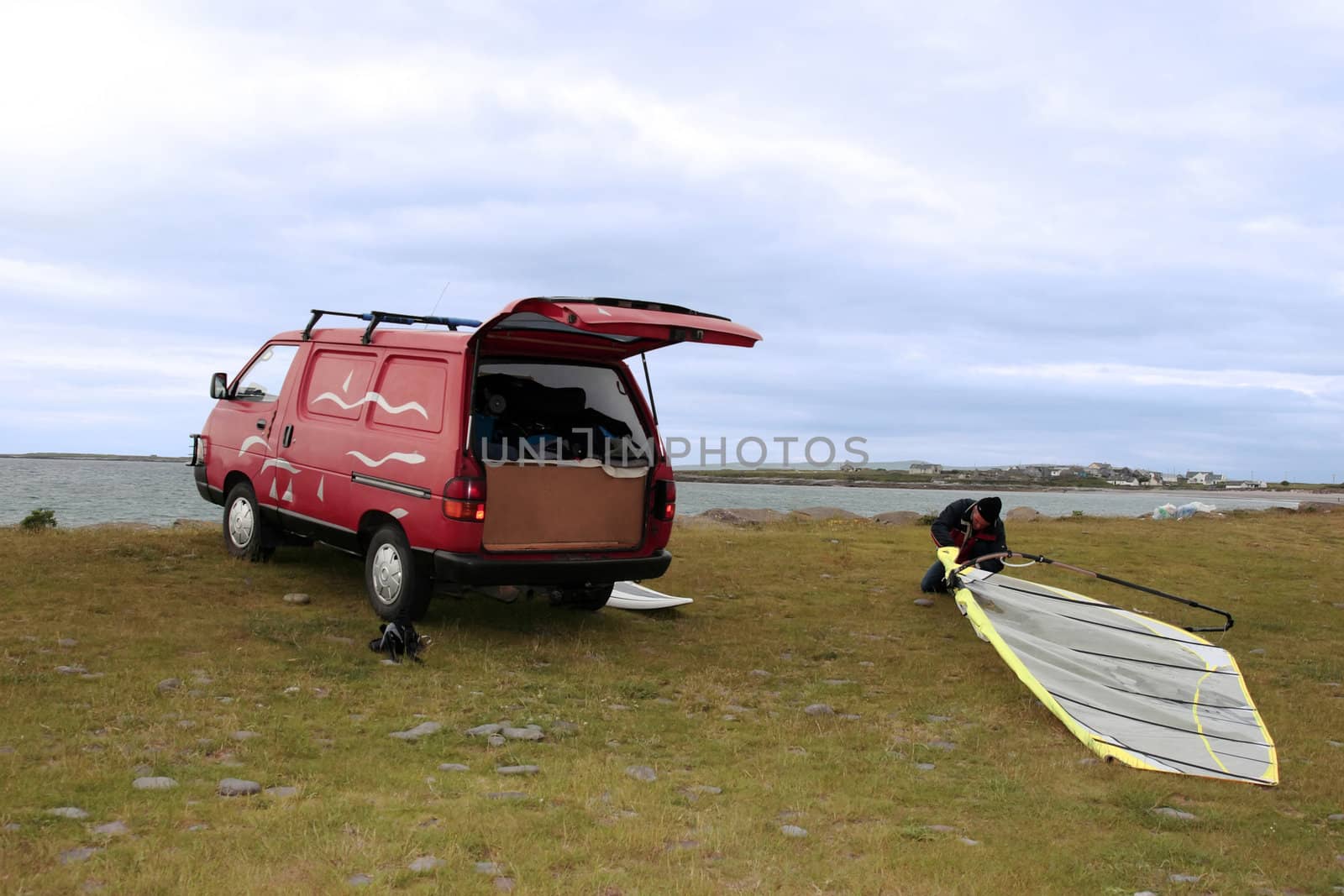 a van and windsurfer getting equipment ready on the beach in the maharees county kerry ireland