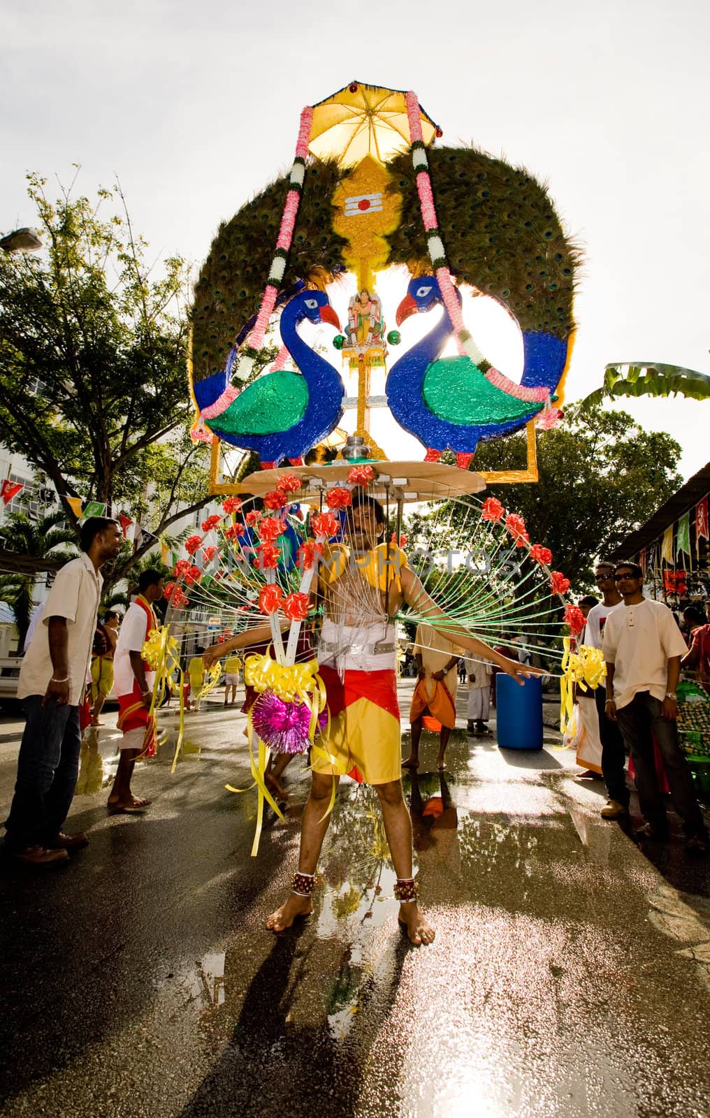man carrying a heavily decorated kavadi for his beliefs