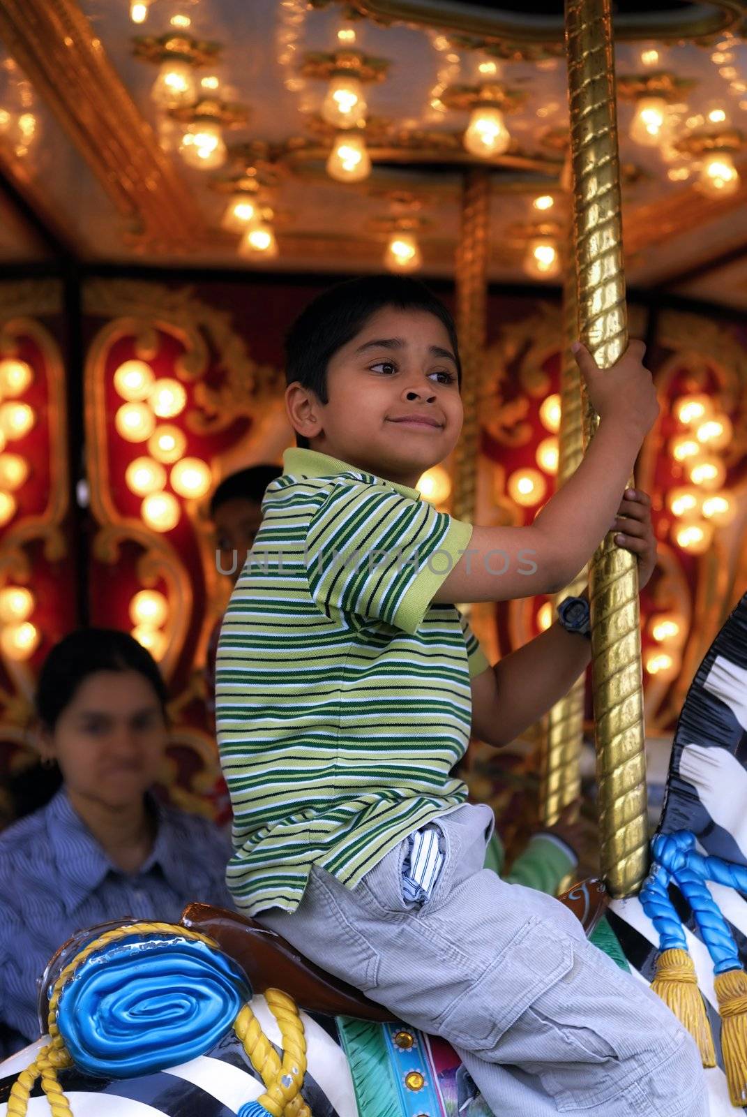 An handsome indian kid having fun at a local carnival