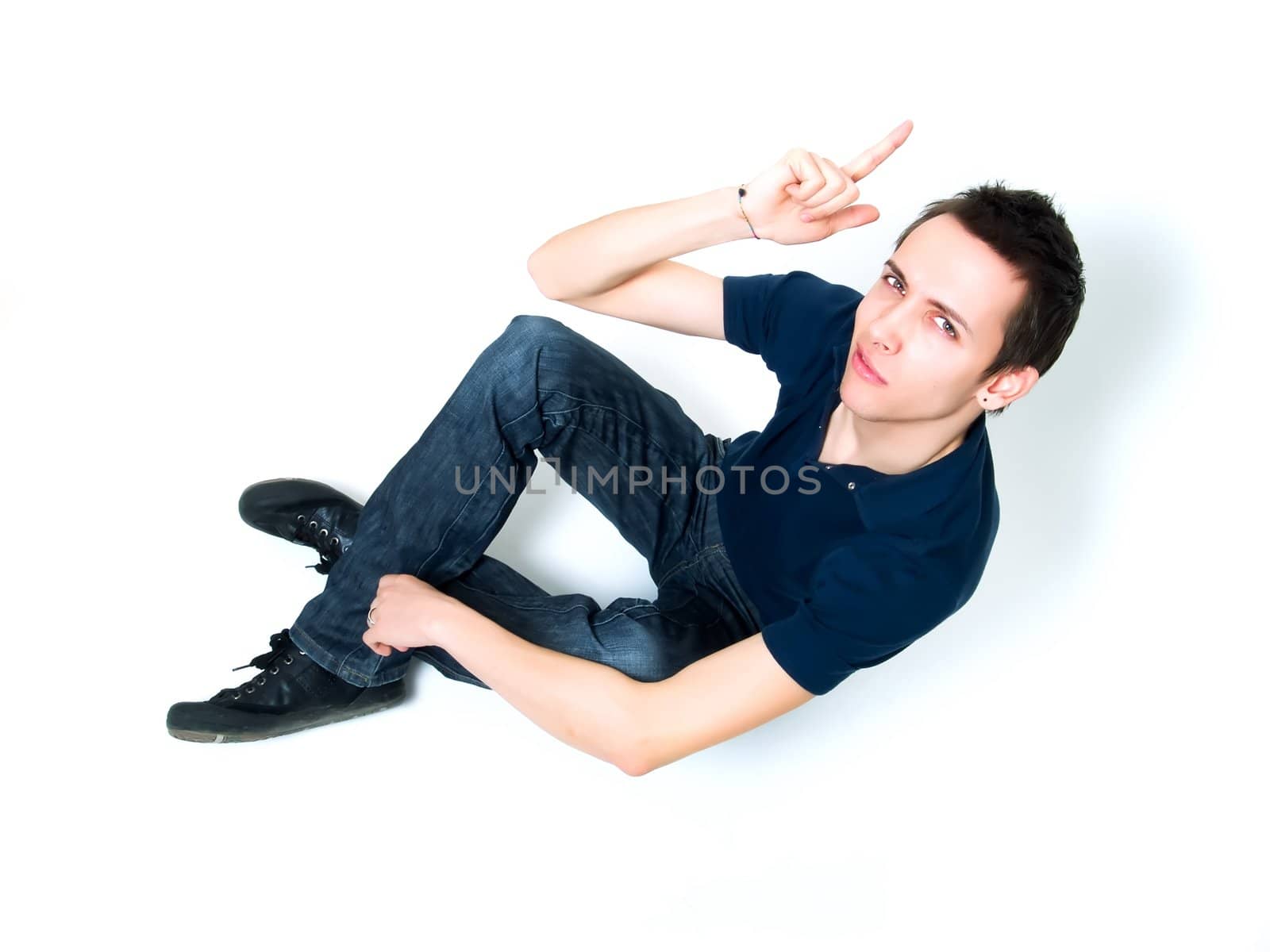 Happy young man pointing at something