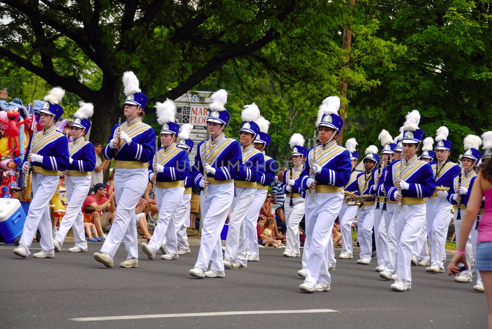 A group of band men playing at a local parade

