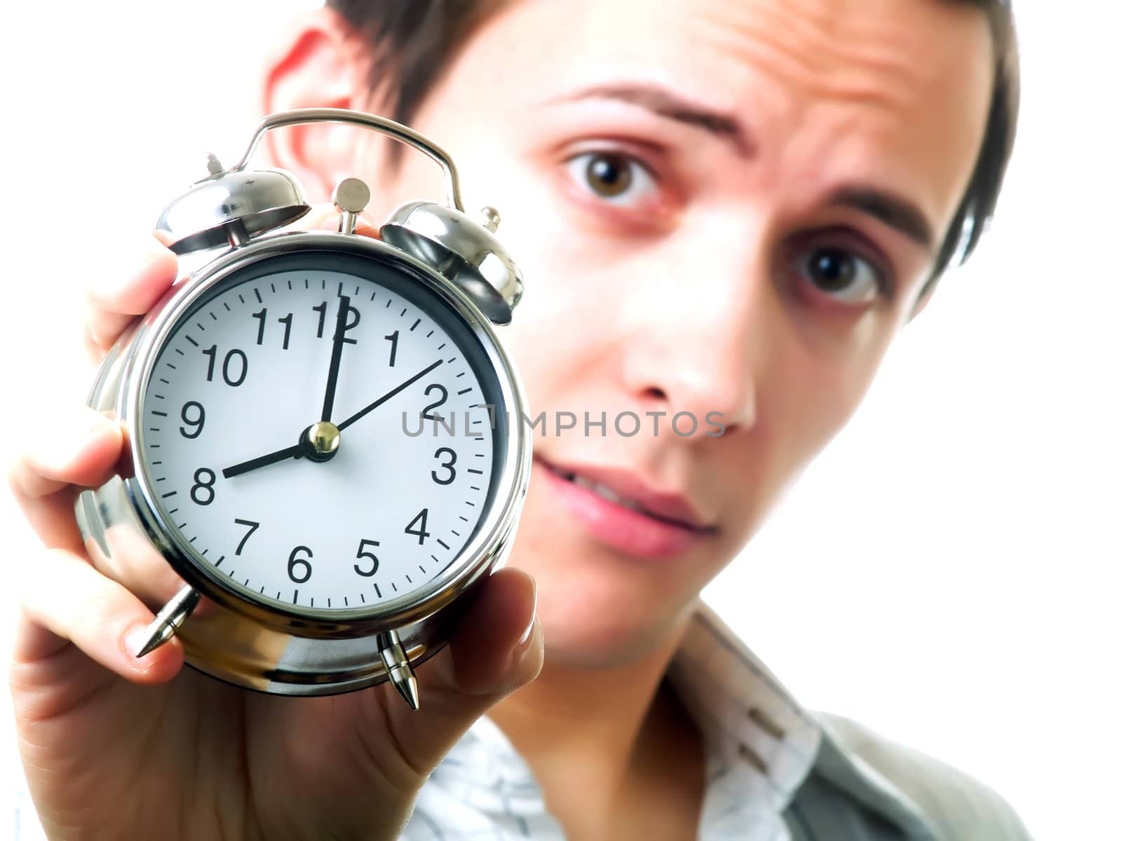 Young man holding an alarm clock