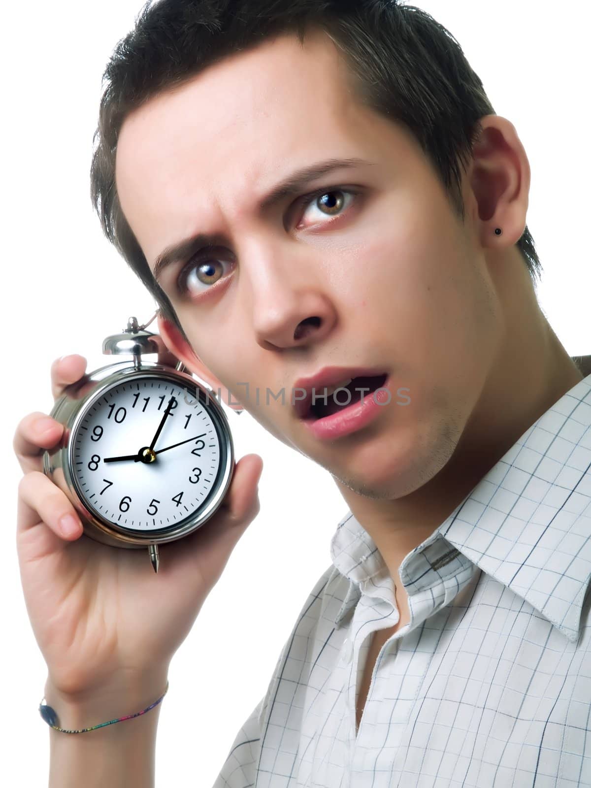 Young man holding an alarm clock