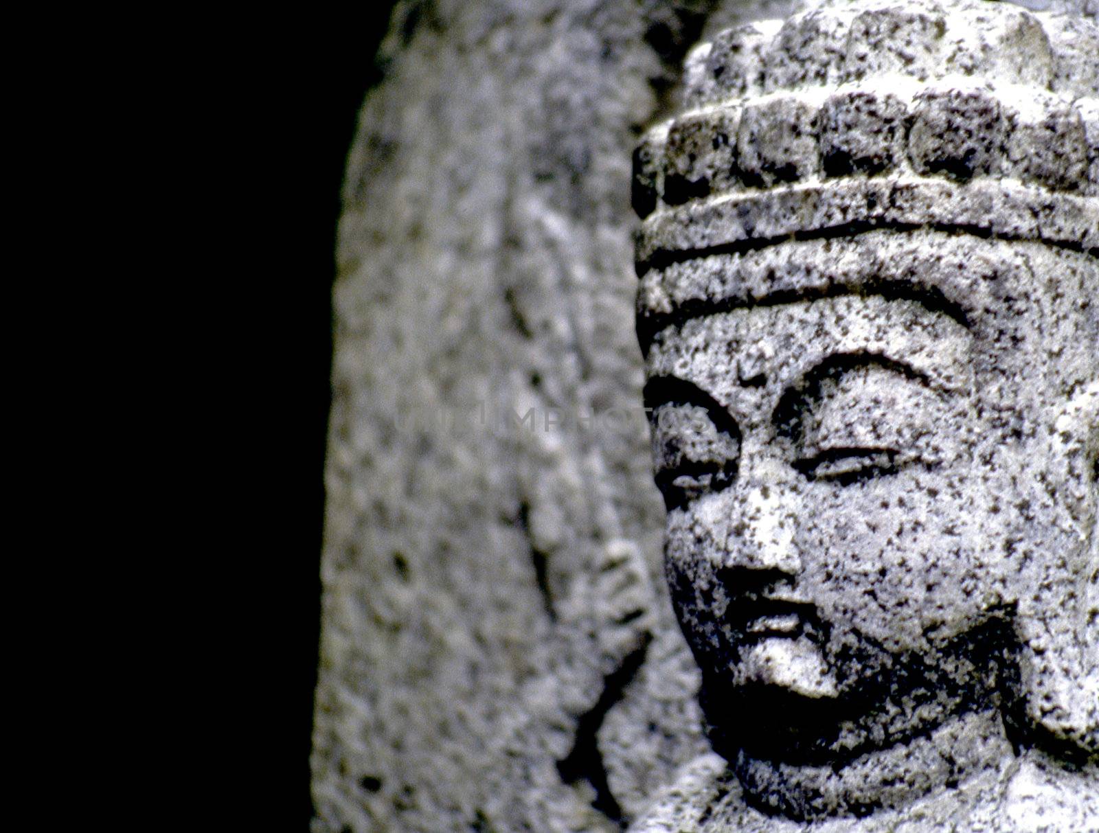 Stone buddha beside mountain trail in Japan. cold and weathered