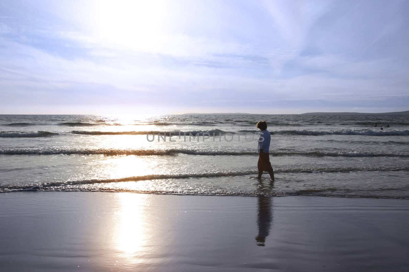 a lady walking in the warm sea