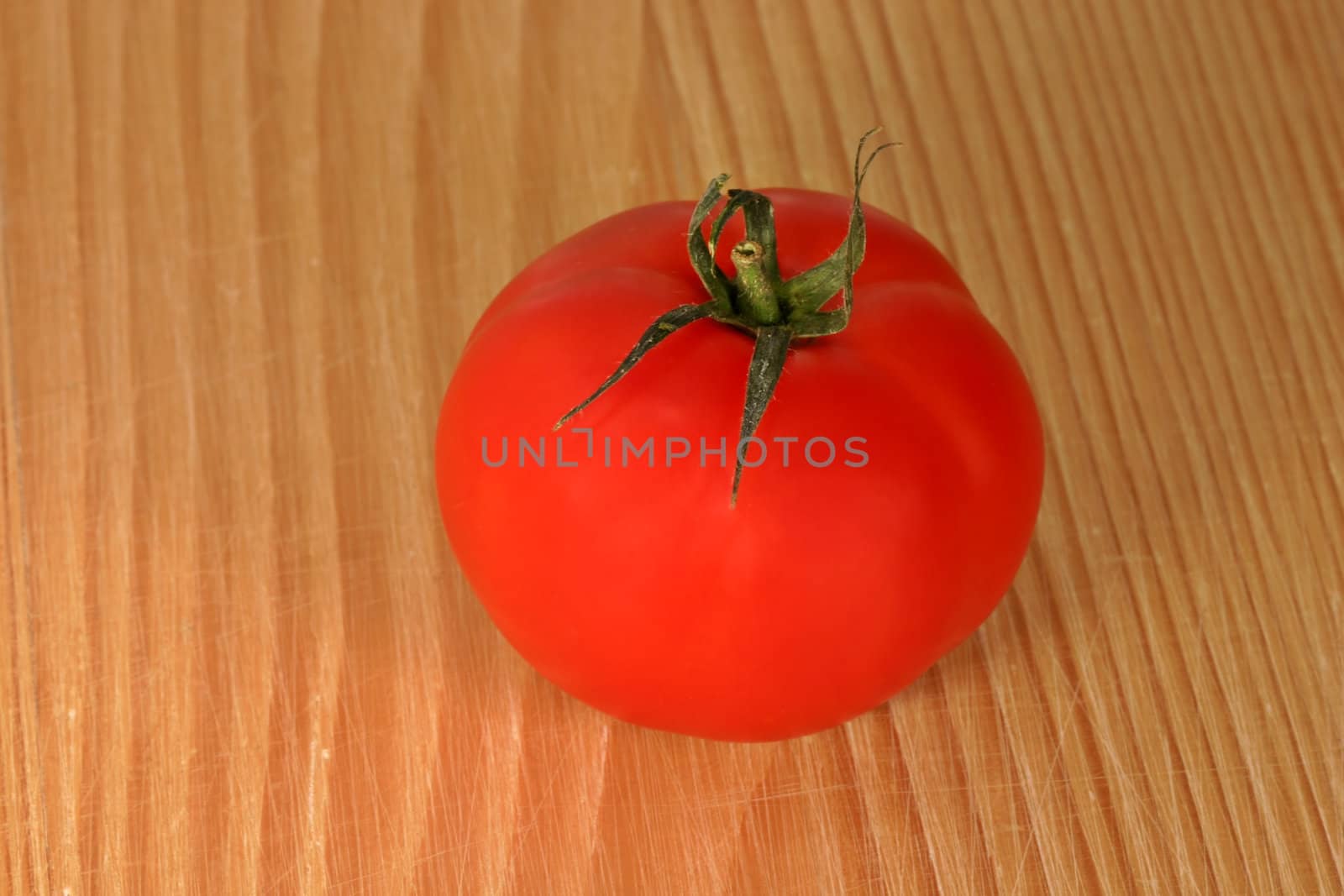 Tomato on wooden board