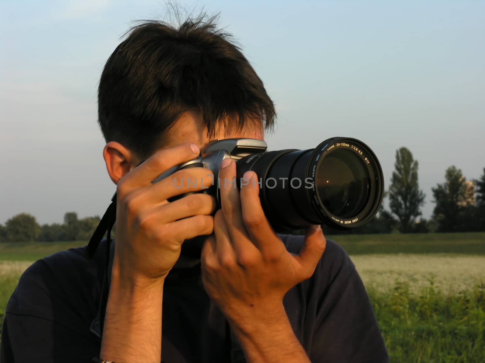 Man photographing with dSLR camera