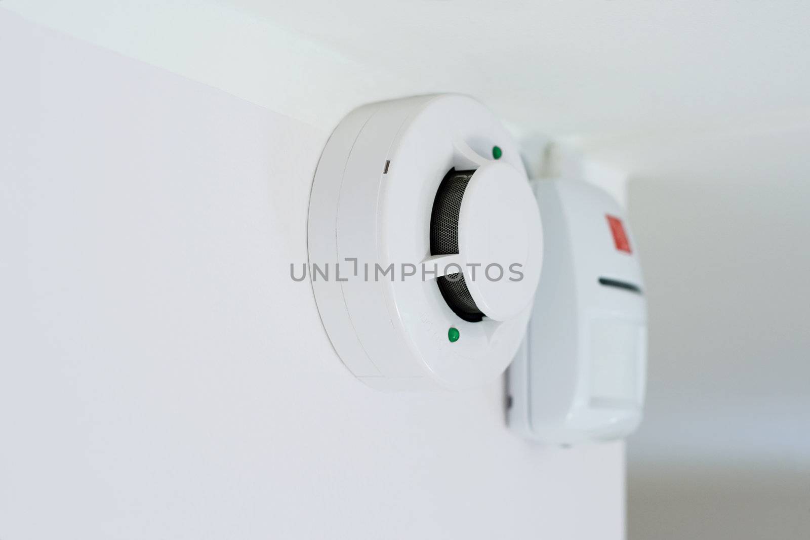 smoke detector and alarm mounted on a wall, shallow DOF