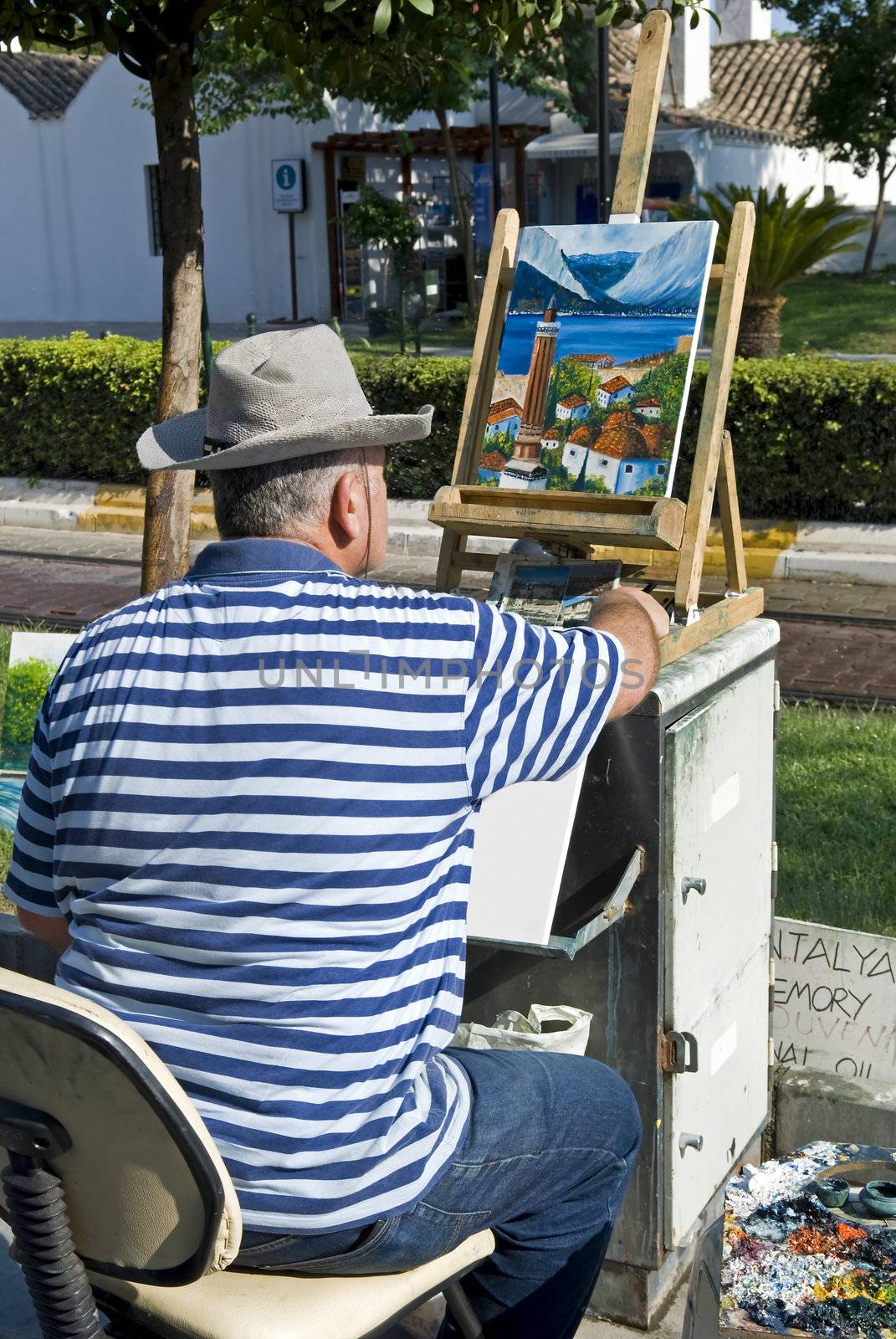 Artist is painting at the street.
