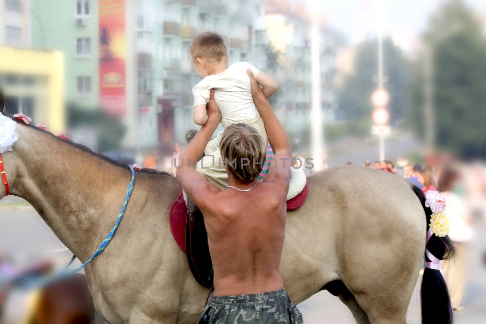 A child learns to ride a horse 