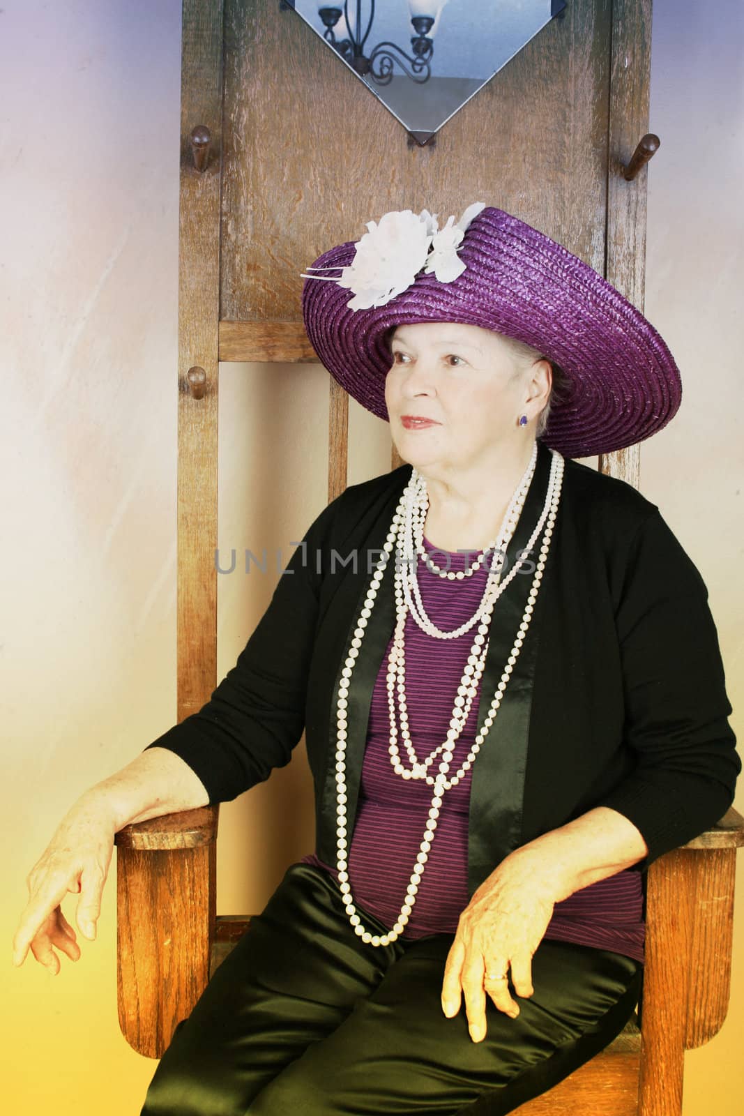 Adult female wearing a purple hat with white flower 