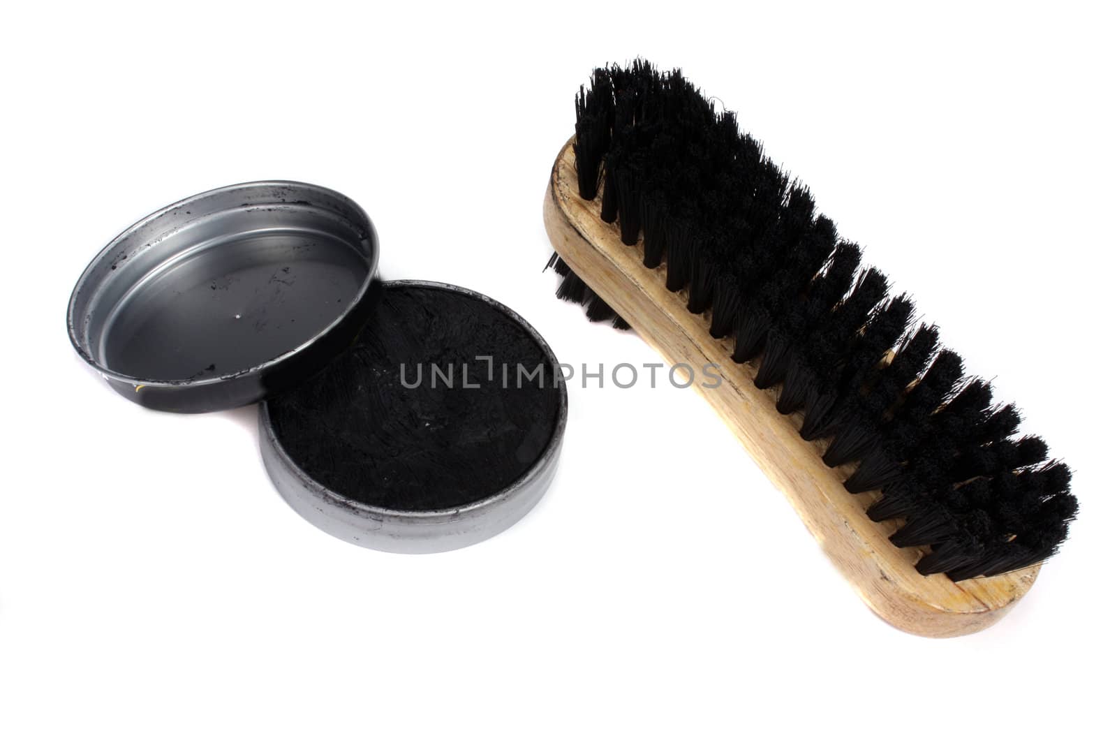 A shoe polish kit consisting of a brush and polish container, on white background.