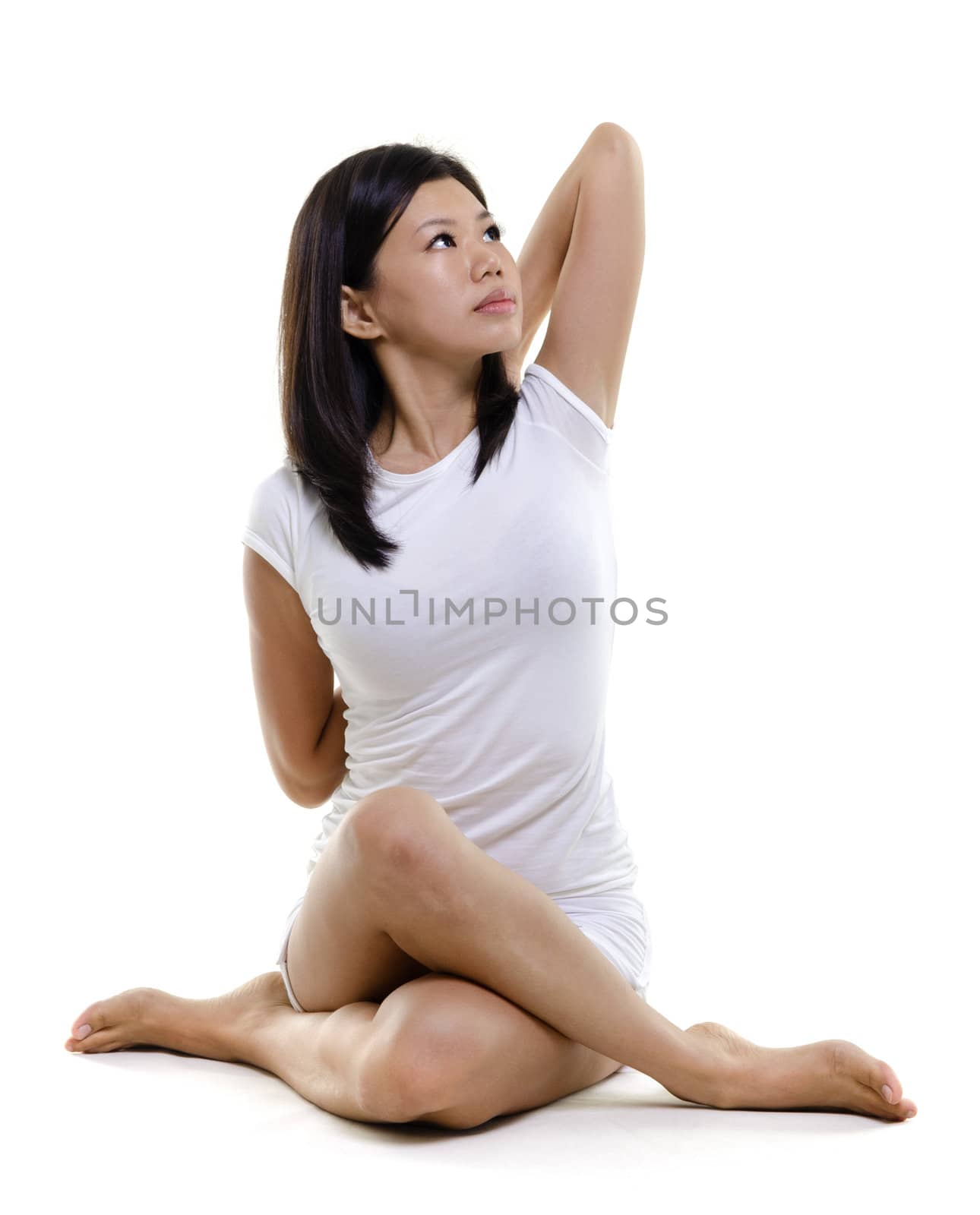 Woman in yoga, Cow Posture (Gomukhasana), on white background