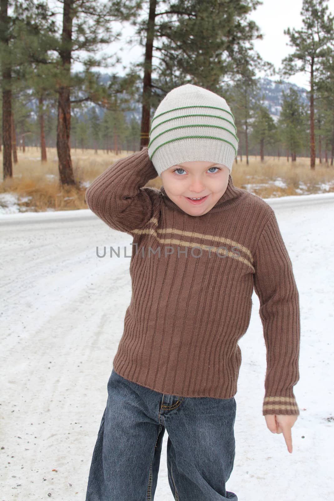 Warmly dressed boy playing outside in the snow