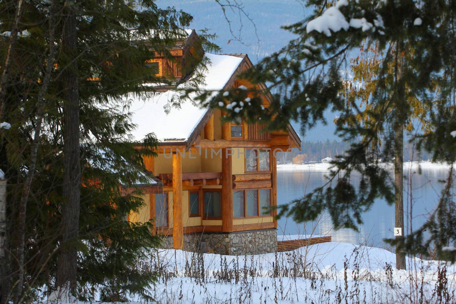 Log Cabin on the shore with snow