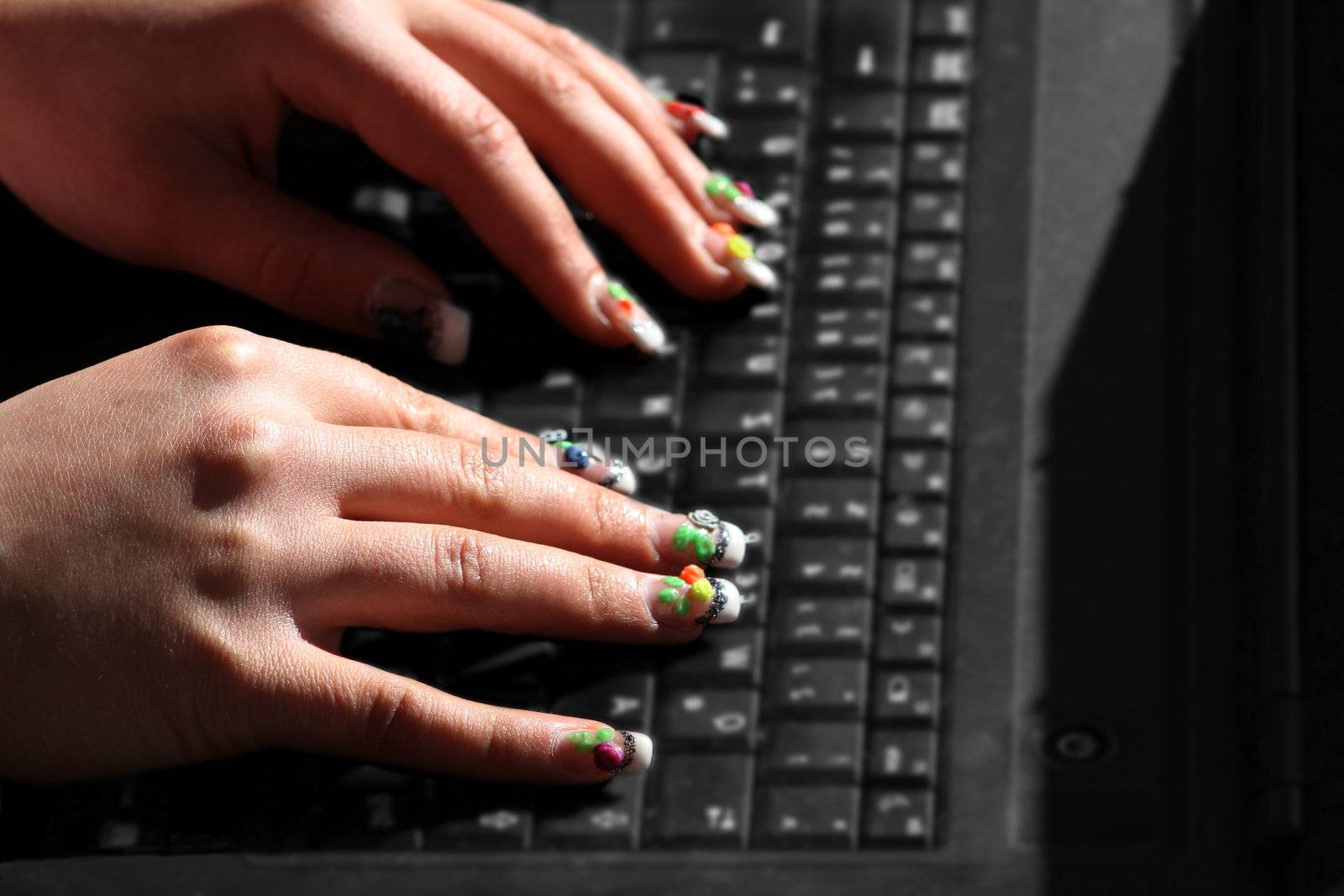 A woman writes a bit on the laptop 