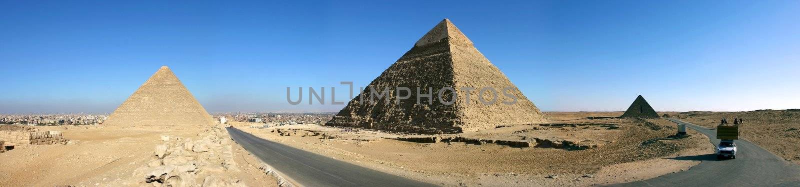 Panorama view of Giza pyramids with a blue sky