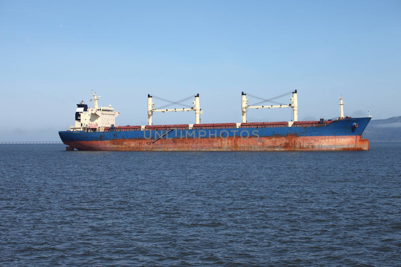 A long cargo ship in the Astoria harbor.