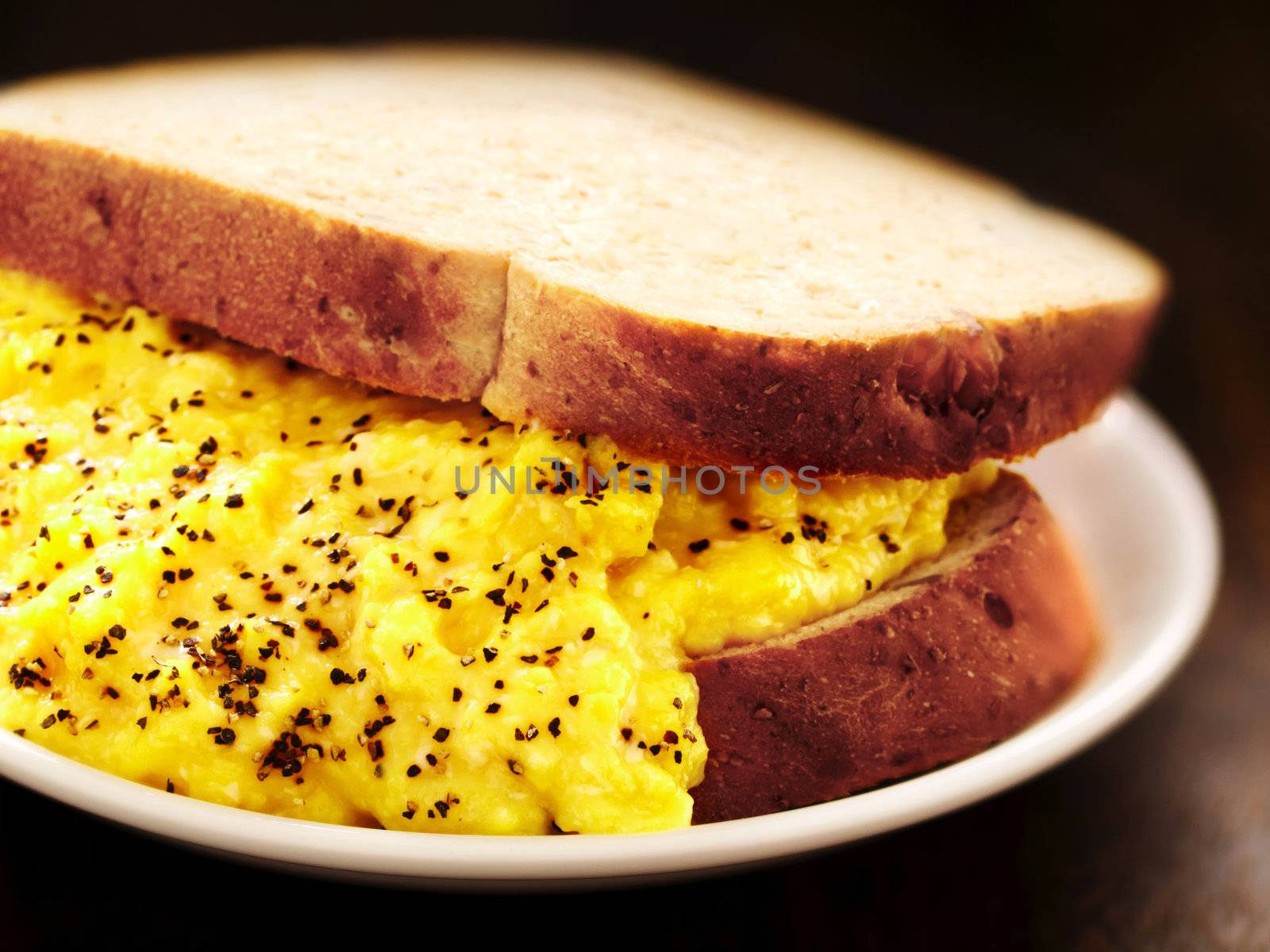 close up of a scrambled eggs sandwich