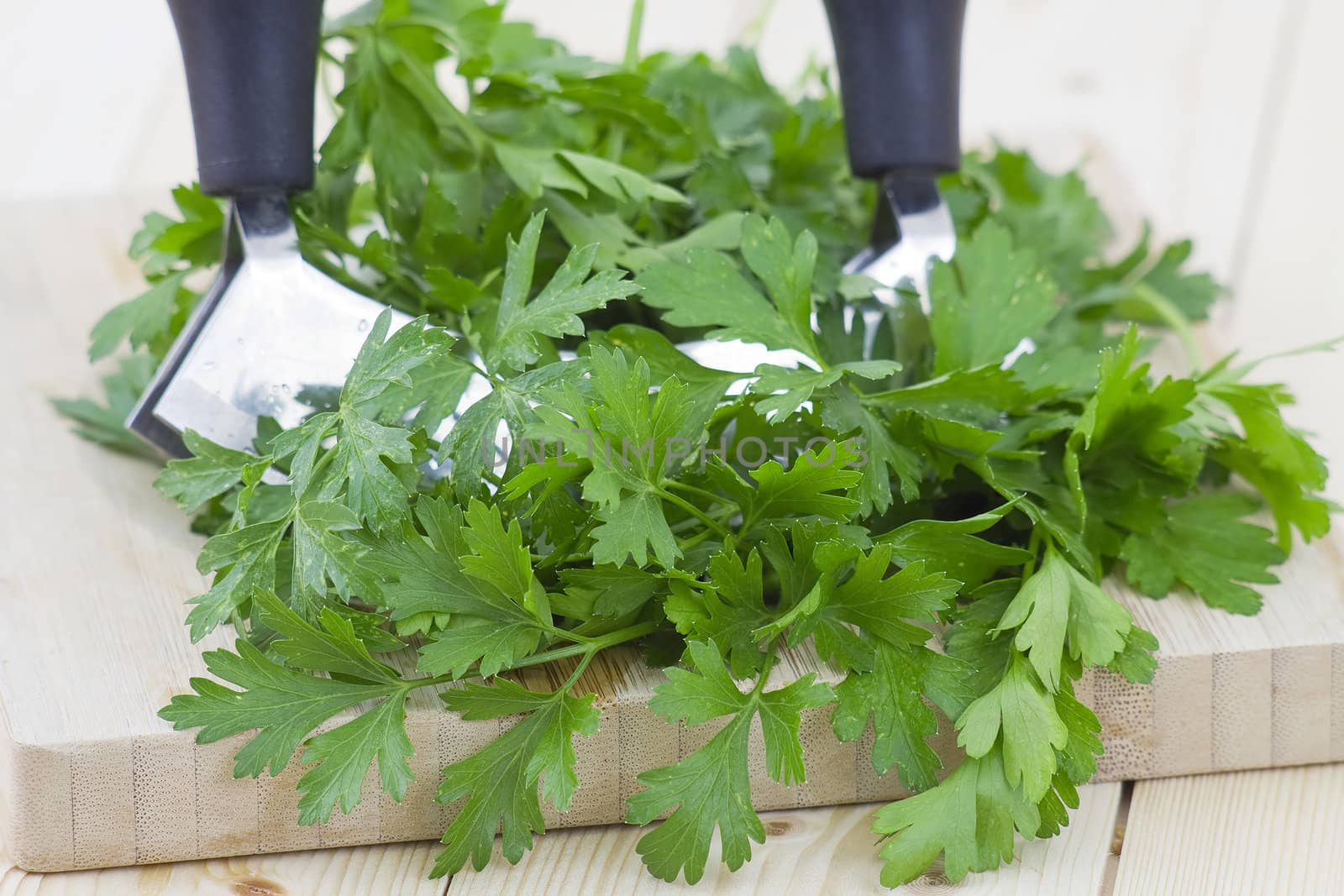 Freshly chopped parsley on wooden cutting board