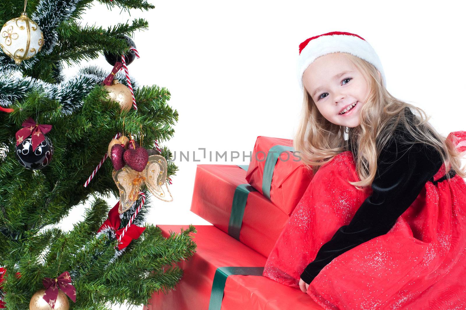 Beautiful baby girl dressed up for Christmas isolated in white