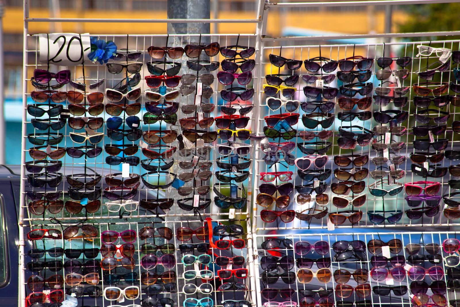 Colorful sun glasses selling on a stand

