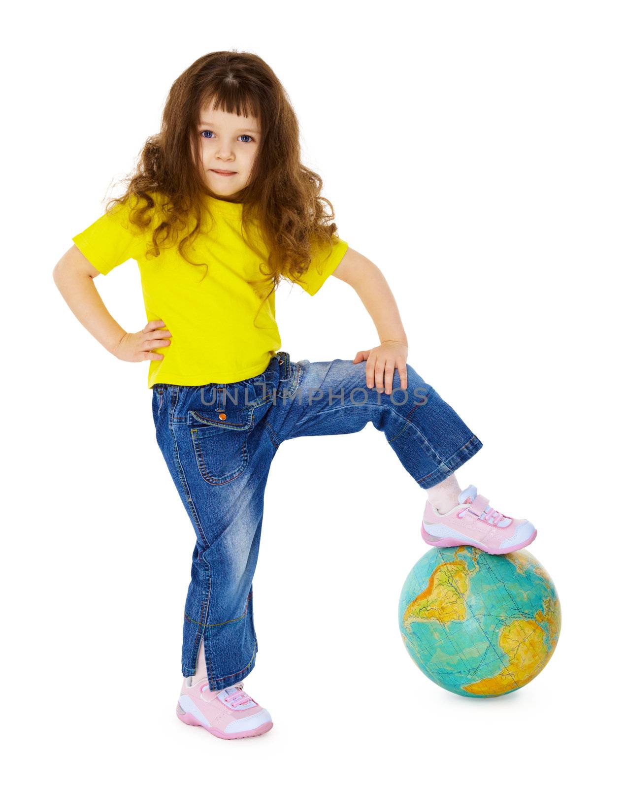 The little girl put her foot on the geographic globe isolated on white background