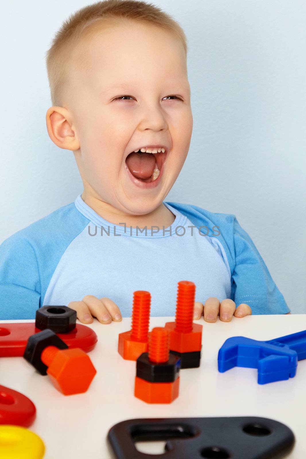 Jubilant children at the table with toys