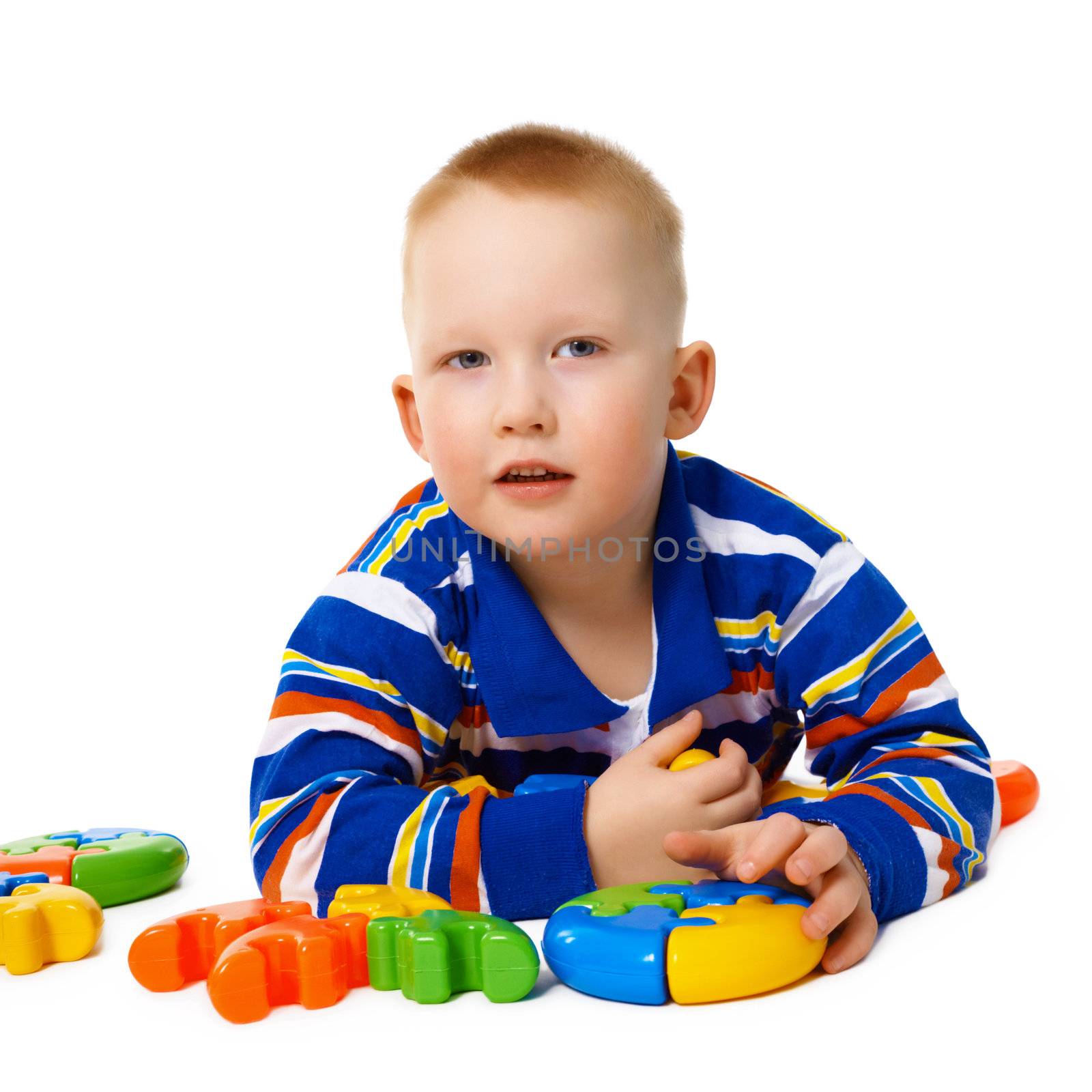 A little boy with color toys isolated on white background