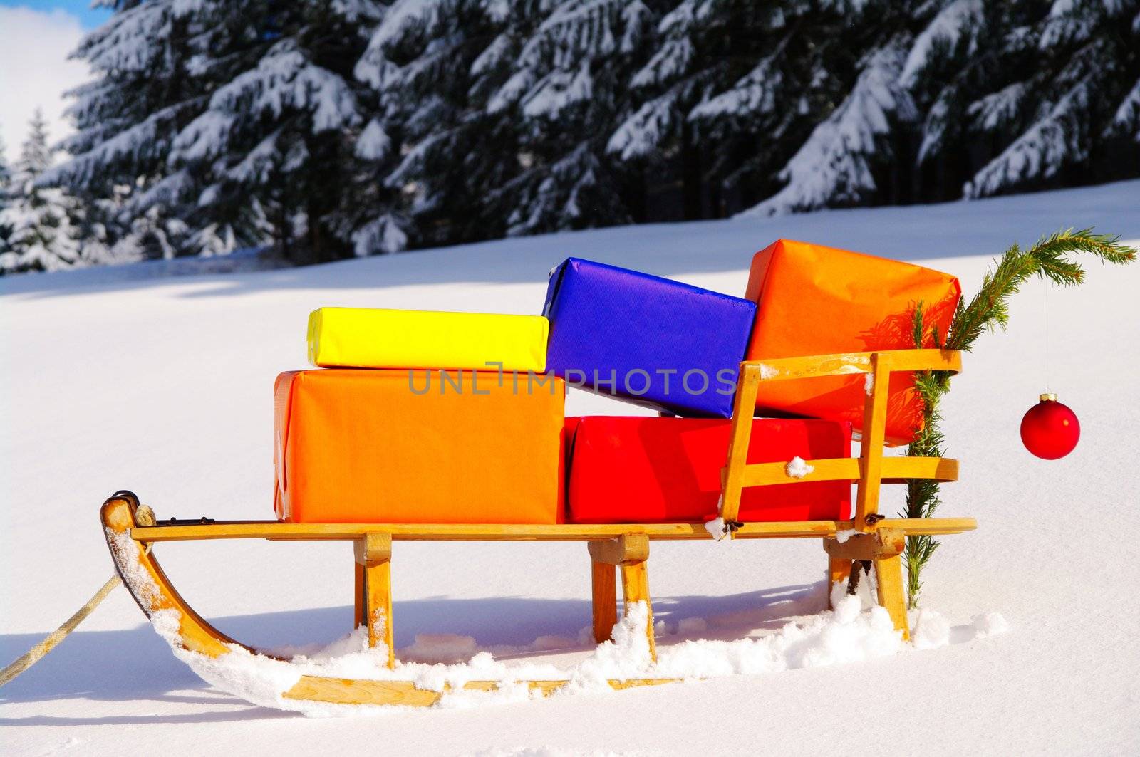 colorful presents on a Santa Claus sledge in a winter landscape