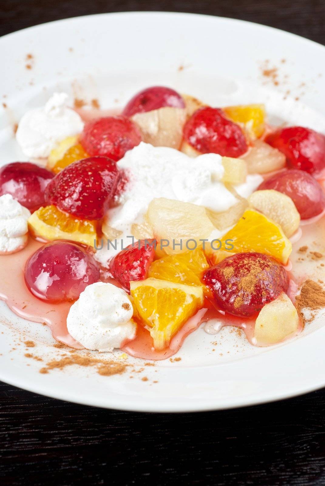 fruit salad of pineapple, grape, orange and strawberry with whipped cream
