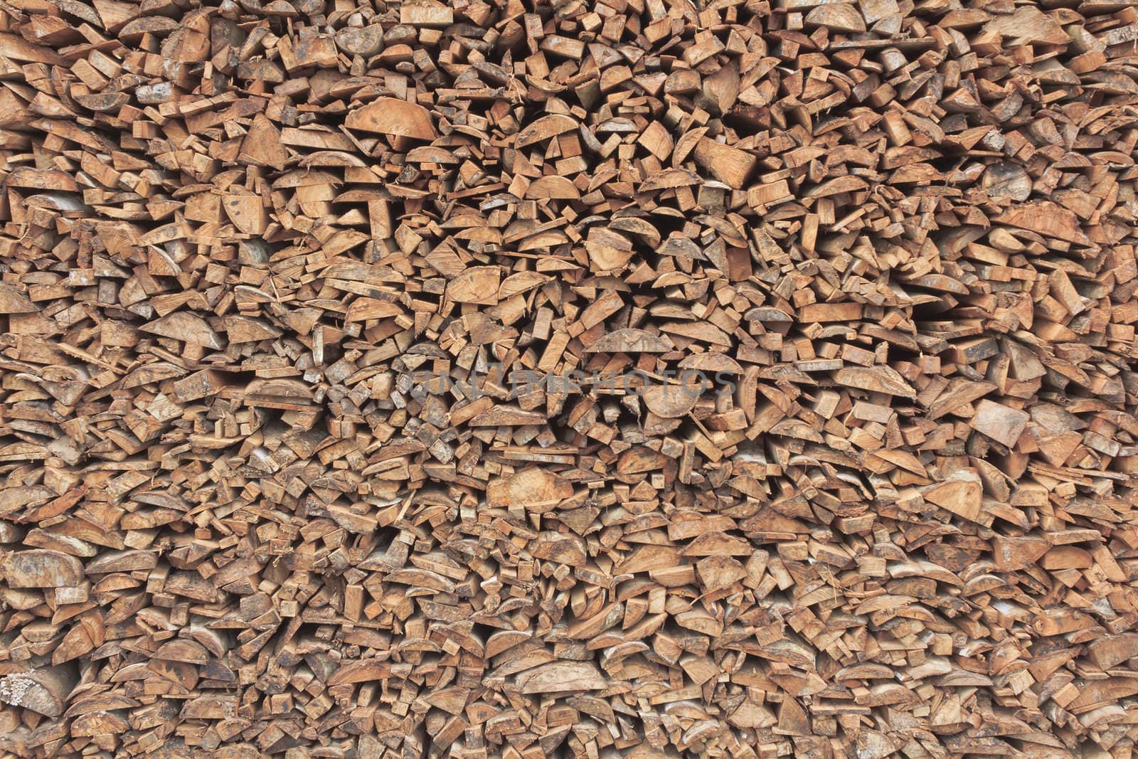 Logs of firewood arranged in a stack background