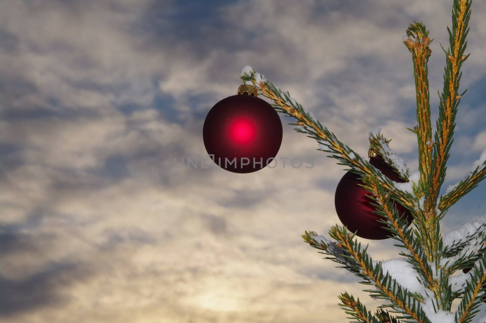 baubles  on a Christmas tree outside in a snowy landscape