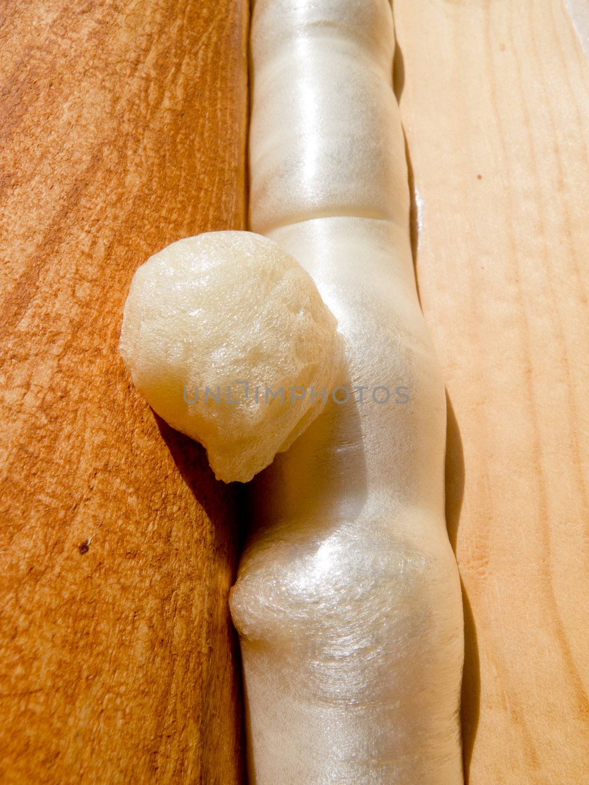Close-up of Polyurethane foam filling gap in wooden construction conserving energy.