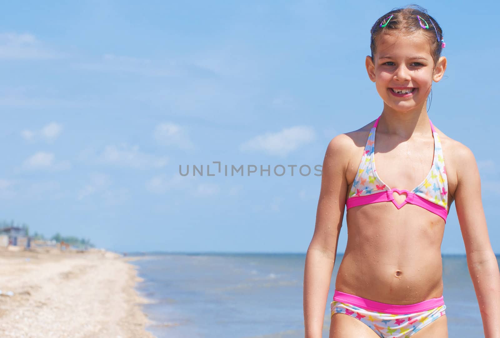 A happy child is running at the beach.