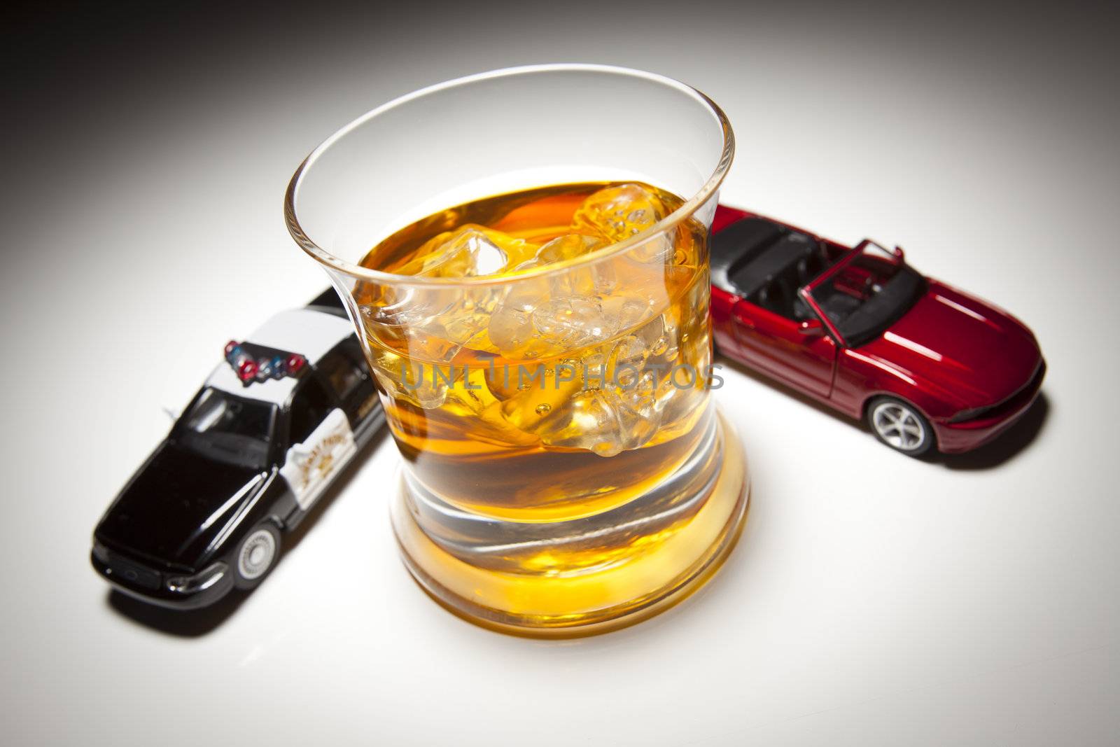 Police and Sports Car Next to Alcoholic Drink Under Spot Light.