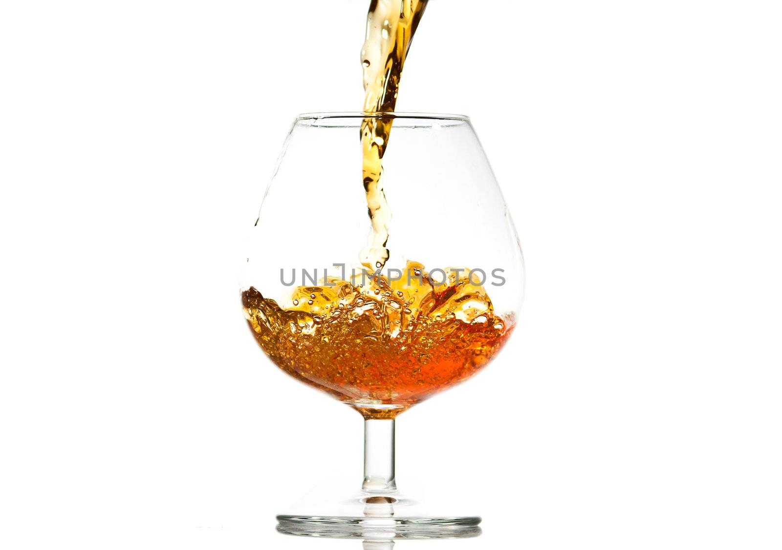 filling a glass of brandy, close-up