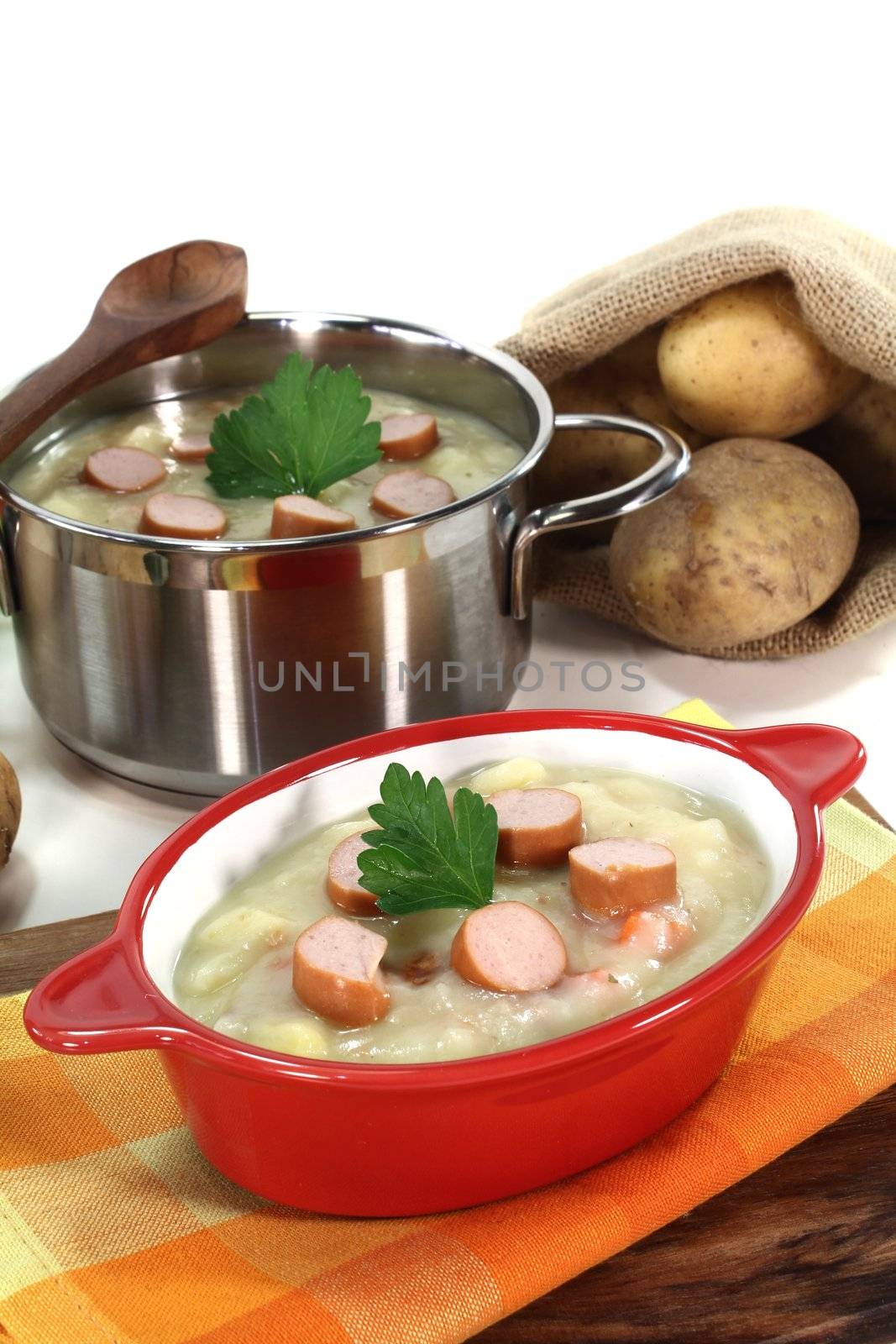 Potato soup with Wiener sausage, greens and parsley