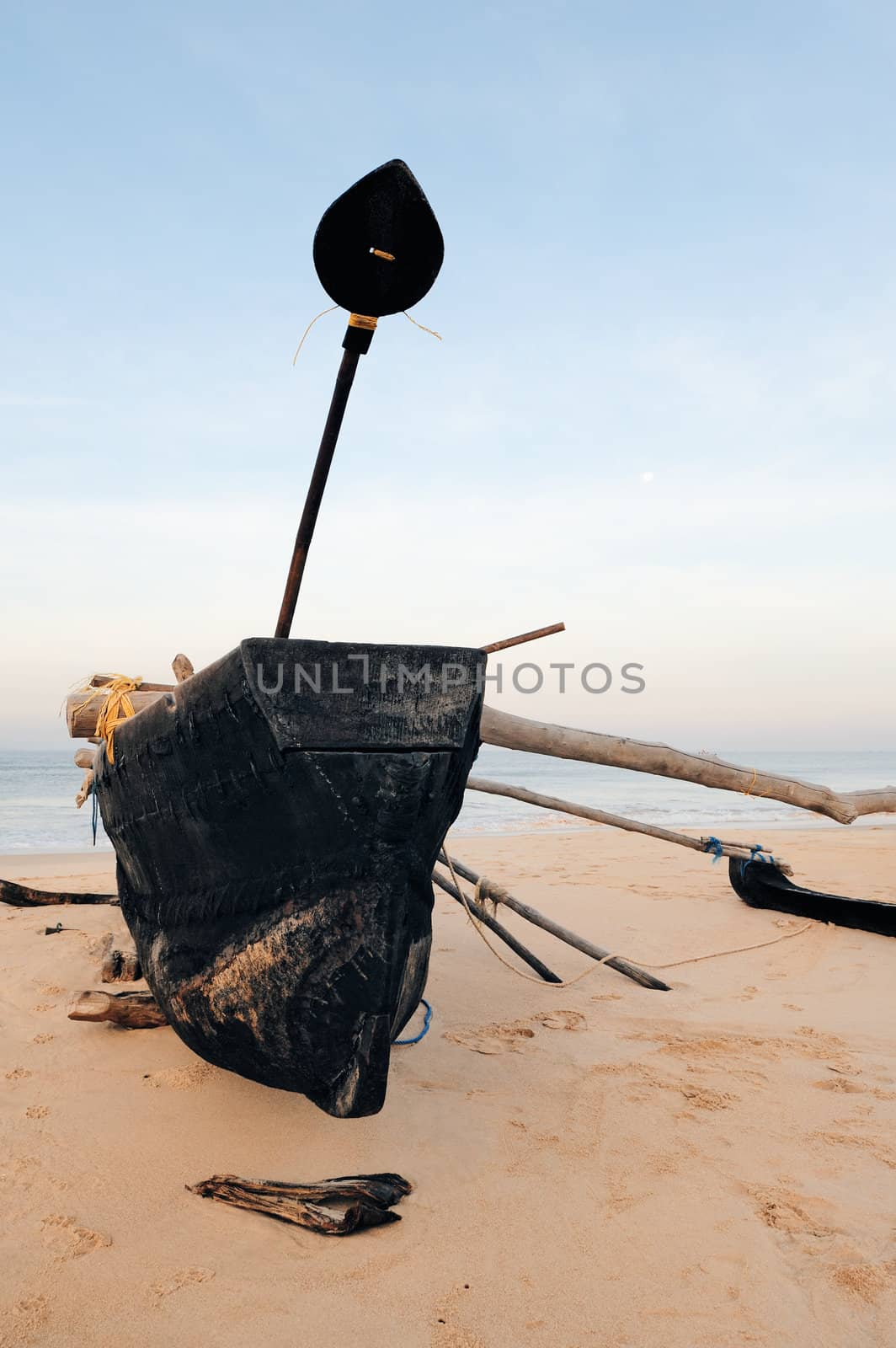 Old fishing boat on the sandy beach in Goa