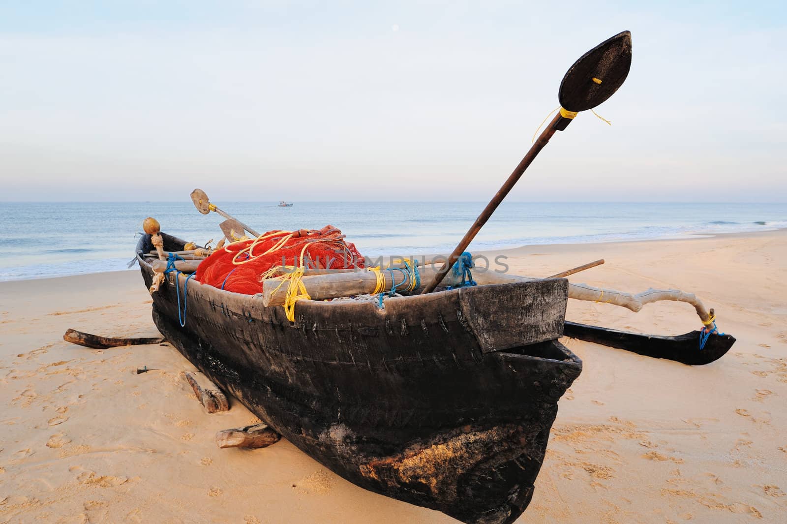Old fishing boat on the sandy beach in Goa