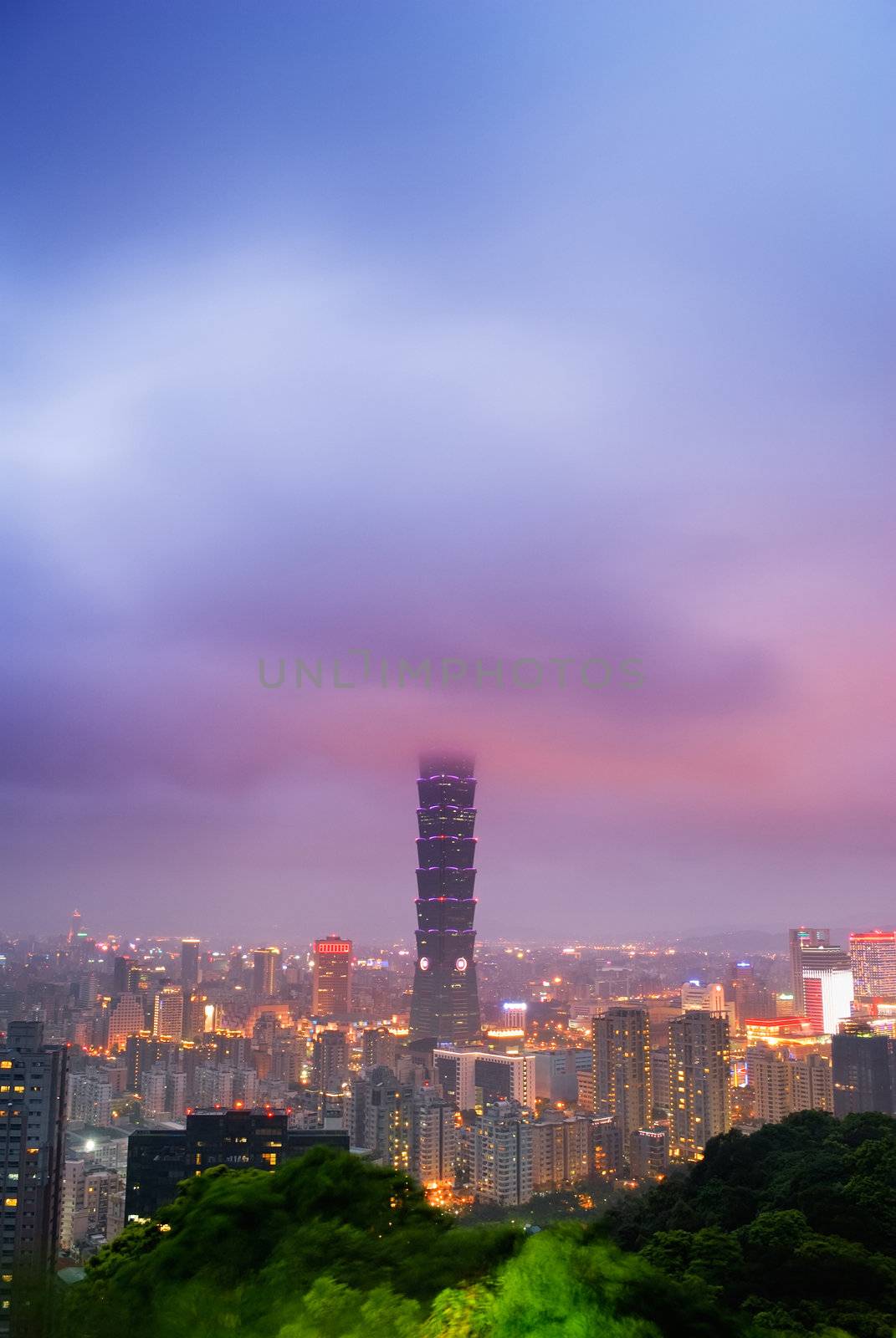 Dramatic landscape of clouds in modern city with skyscraper in night in Taipei, Taiwan.