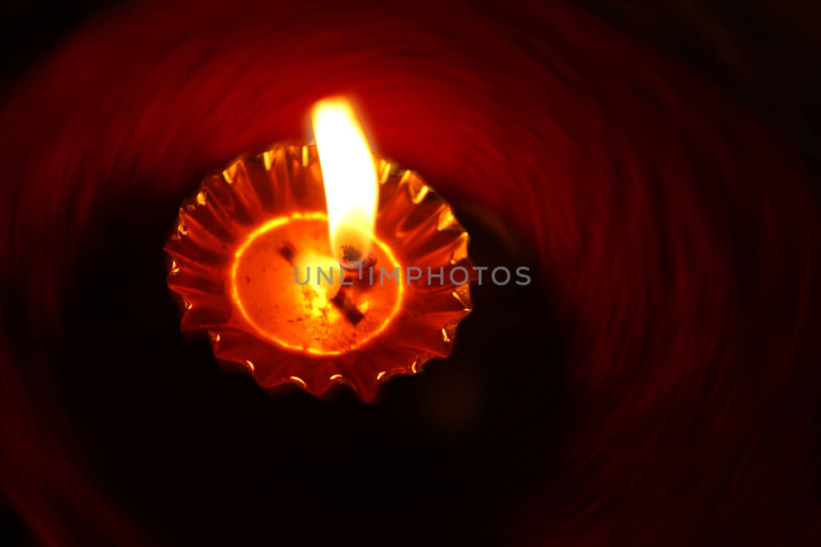 A background of a traditional Diwali lamp with a rotating design.