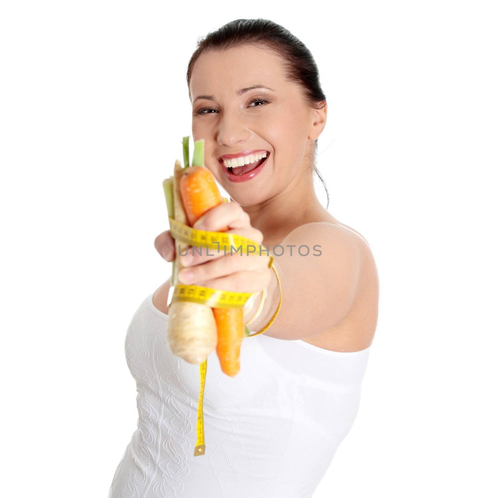 Woman's hand holding vegetables and measuring tape, isolated on white. Diet concept
