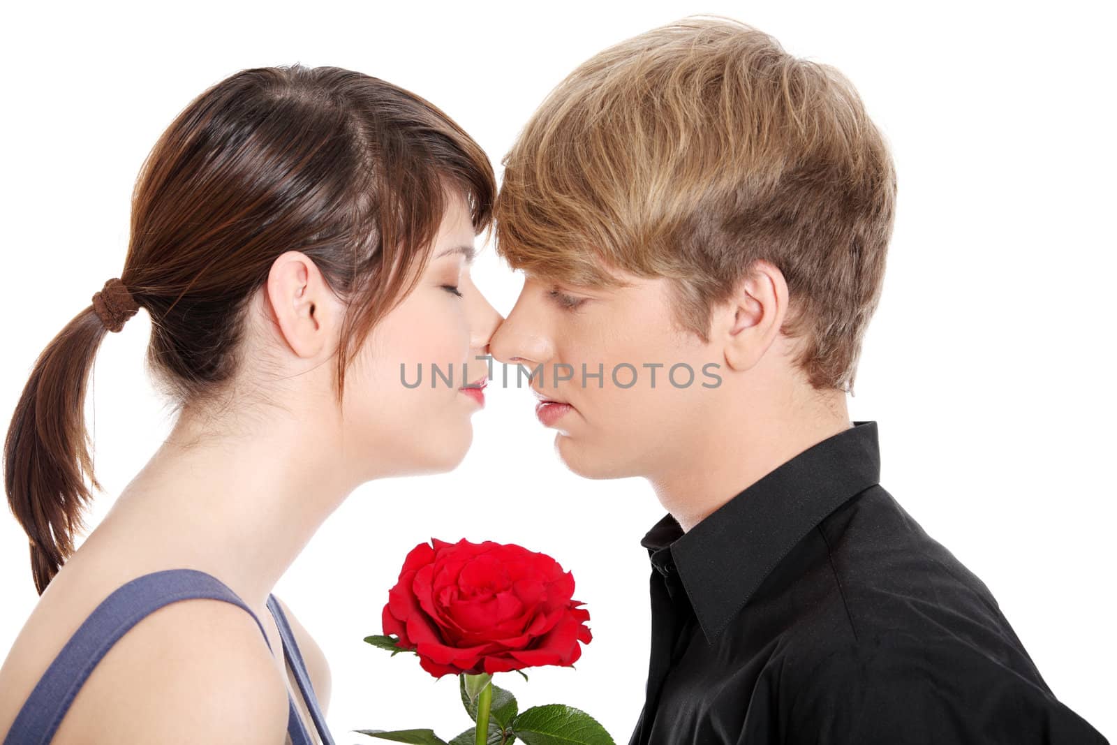 Kissing young couple. Isolated on white background.