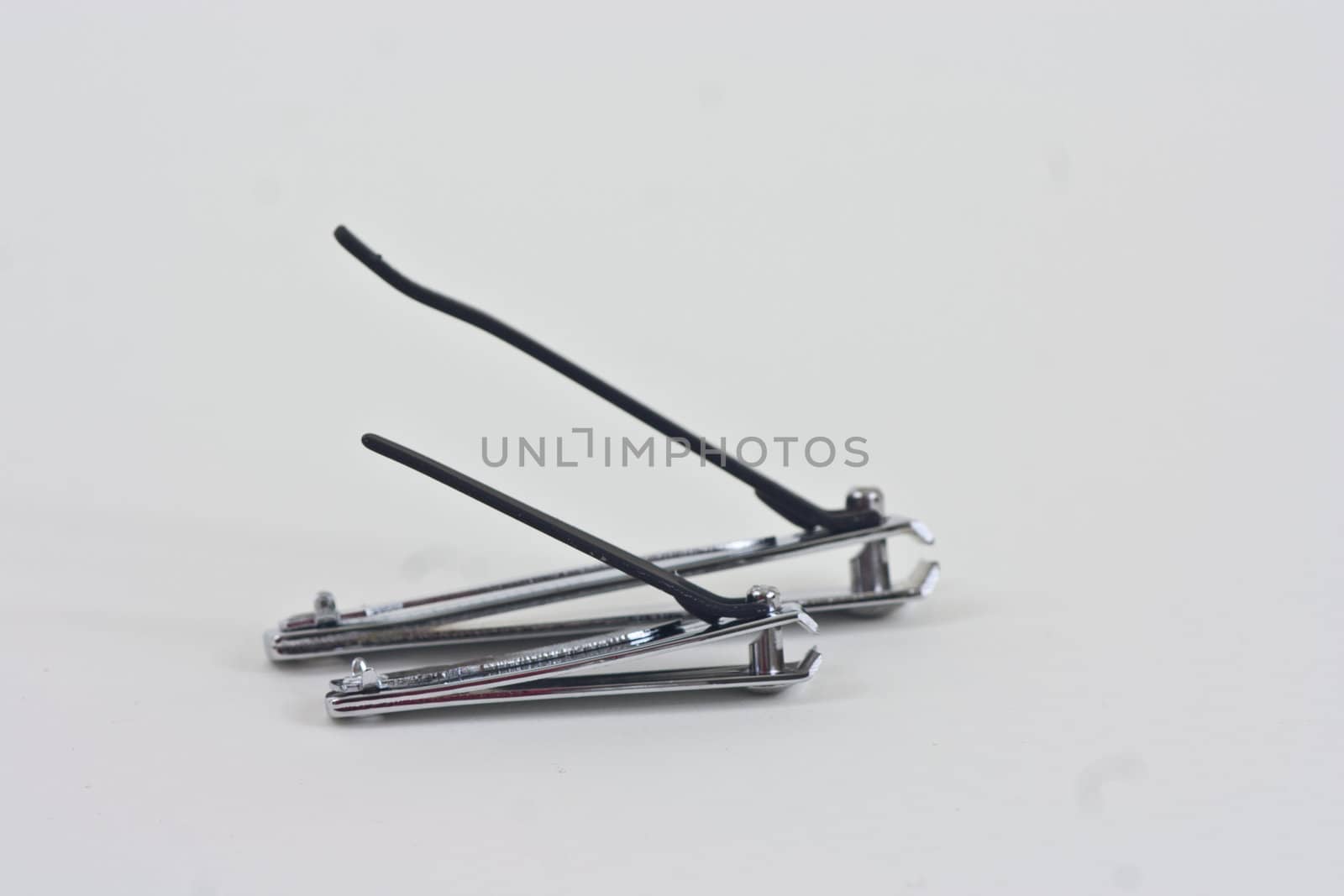 A pair of large and small finger and toe nail clippers on a white background