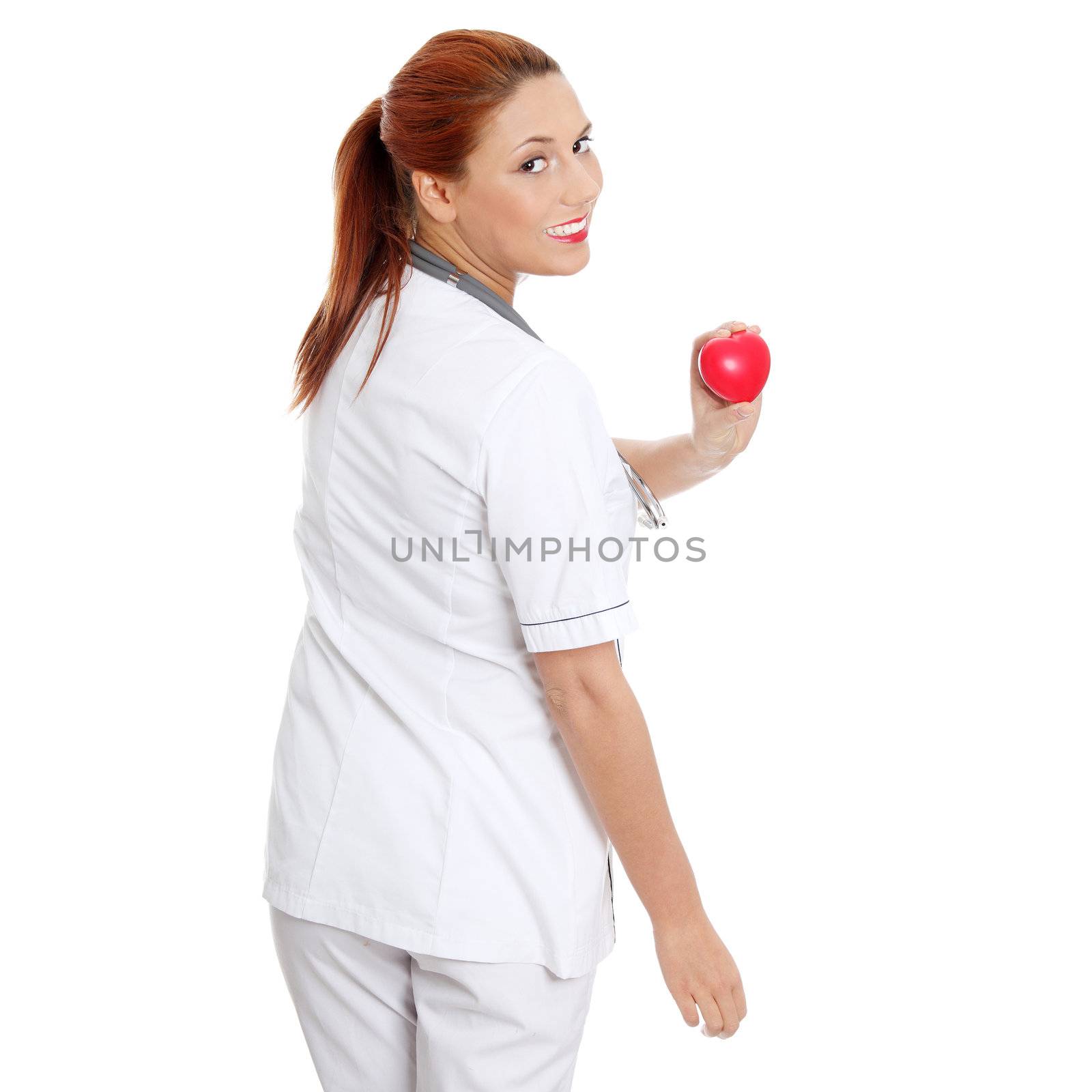 Female doctor with stethoscope holding heart. Isolated on white