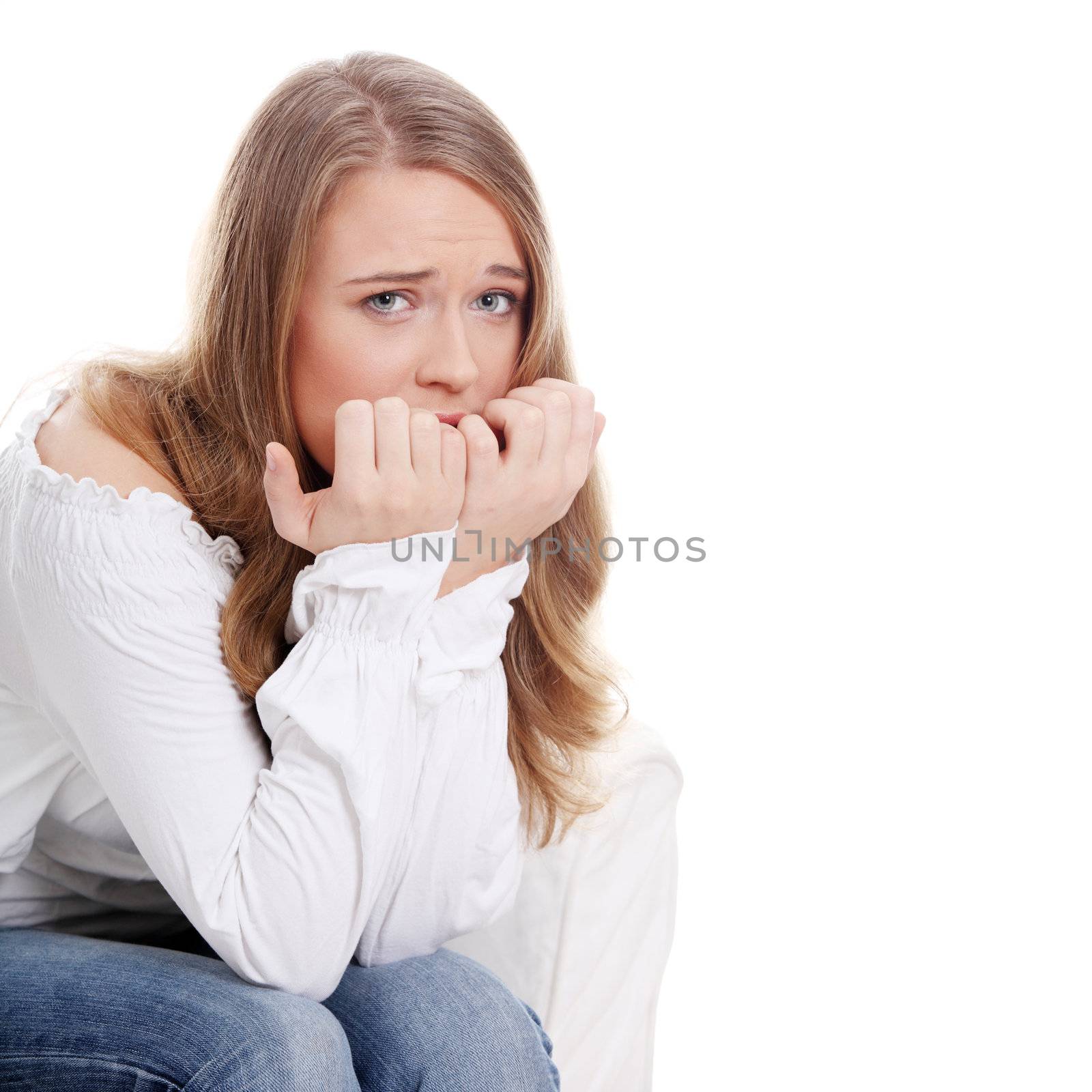 Stressed young woman eating her nails by BDS