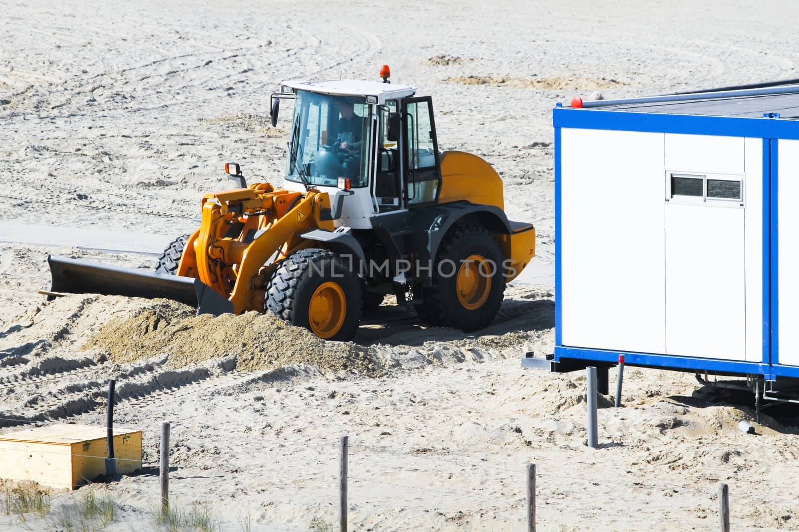 Work at the beach - equalizing sand for placing cabins to prepare for the summer season