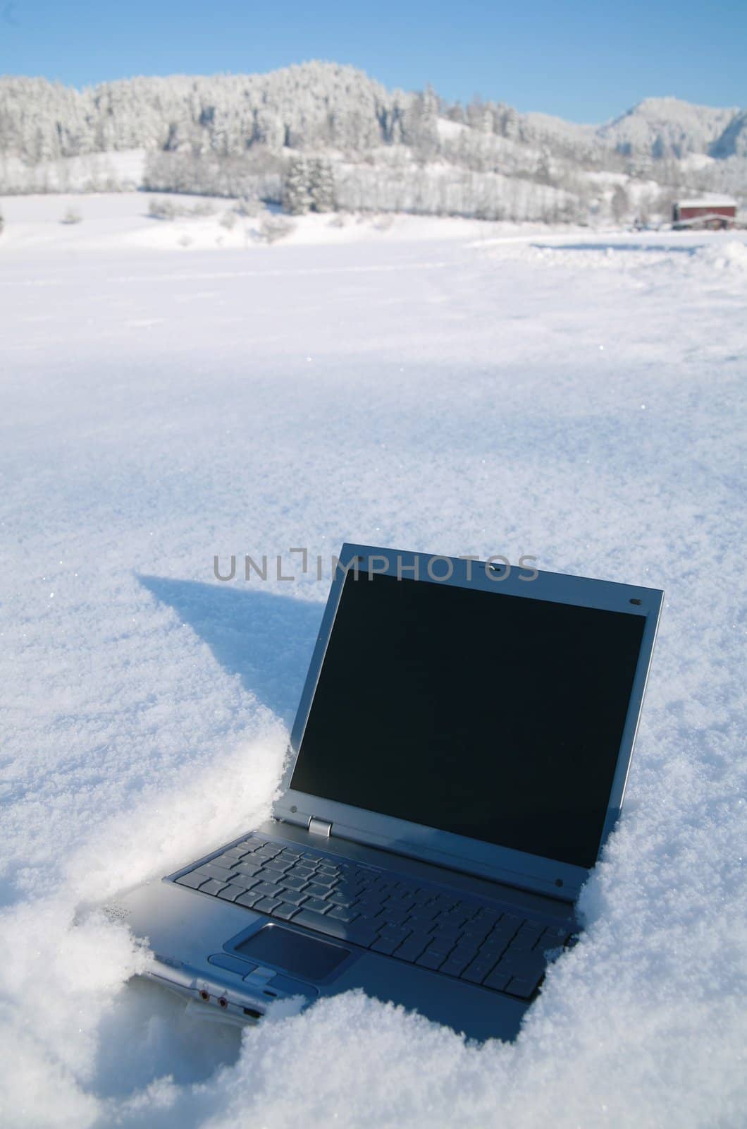 Laptop in a snowy winter landscape scene